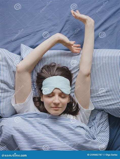 Top View Of A Woman In Bed Wearing A Sleep Mask A Happy European Woman