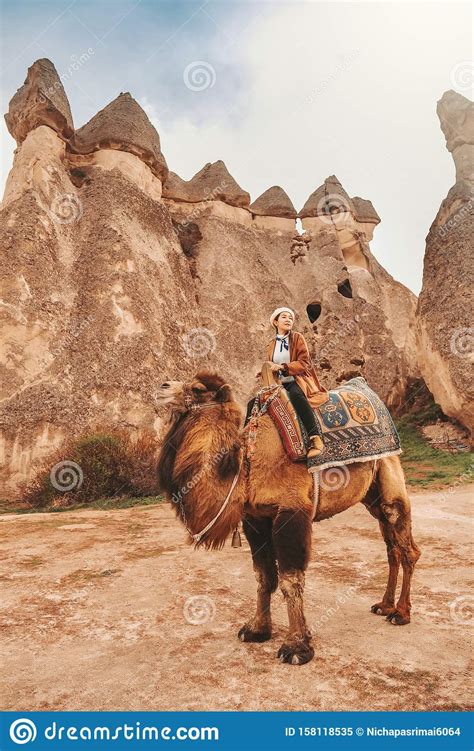 Traveler Woman Riding Camel At Goreme Fairy Chimneys