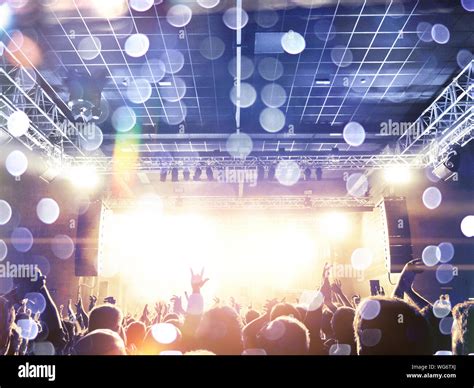 Concert Crowd Clapping In Front Of A Bright Stage Stock Photo Alamy