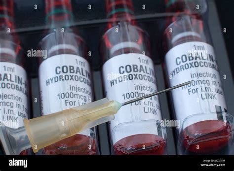 Vitamin B12 Ampoules For Injection With A Hypodermic Needle Stock Photo