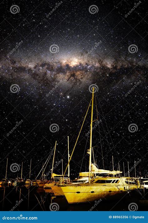 Night Sky Showing Stars And Milky Way With Boats In The Foreground