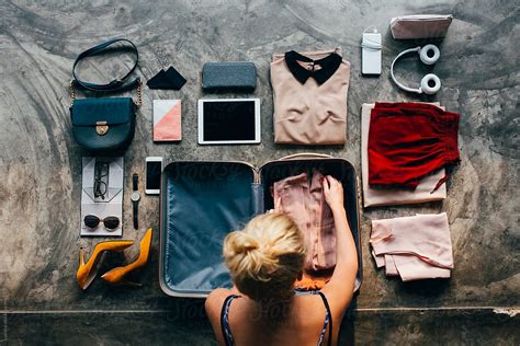Woman Packs Her Suitcase By Stocksy Contributor Lumina Stocksy