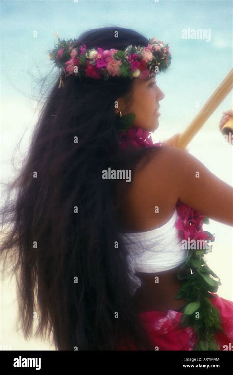 Hawaiian Woman In Haku Head Lei Using Puili Bamboo Sticks On The Beach