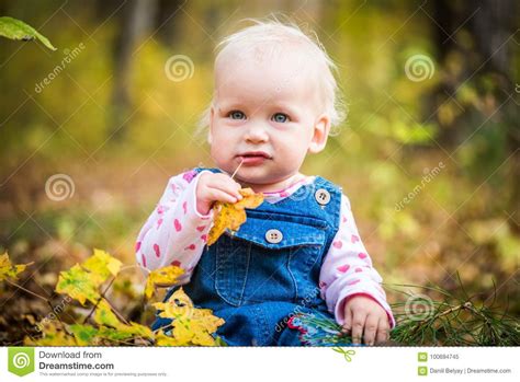Happy Baby Girl Laughing And Playing In The Autumn On The Forest Stock
