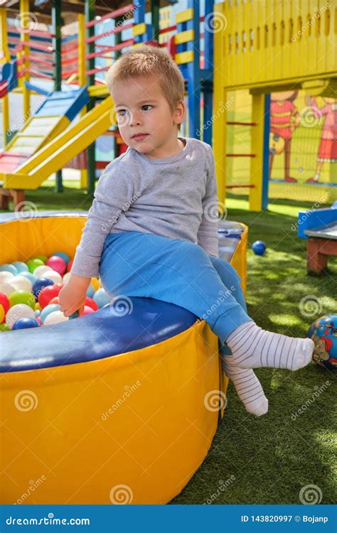 Little Boy Playing With Colorful Balls In Park Playground Stock Image