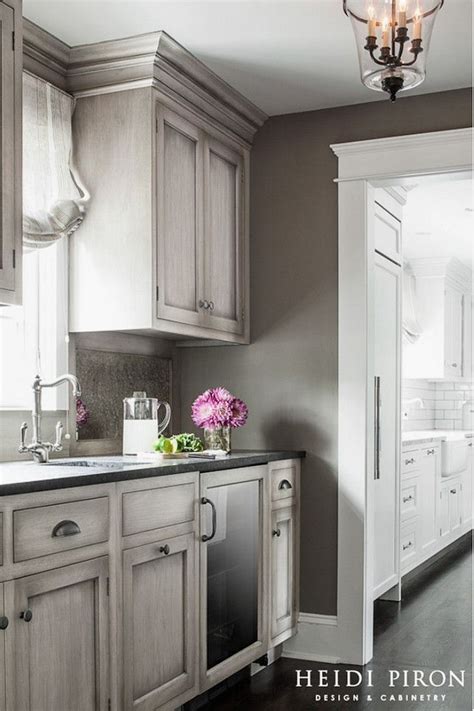The wall white cabinets and the gray backsplash tiles complement the island cabinets and the marble countertop! Like the stained weathered gray cabinet finish. # ...