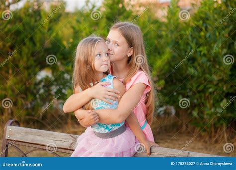 Two Little Girls Sisters Hugging And Having Fun In Park Stock Image