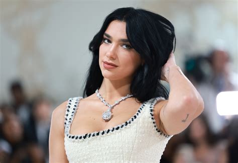 Dua Lipa Raises The Temperature Posing In A Thong Bra And White Dress