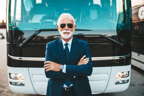 Premium Photo Mature Beard Bus Driver Standing In Front Of Bus