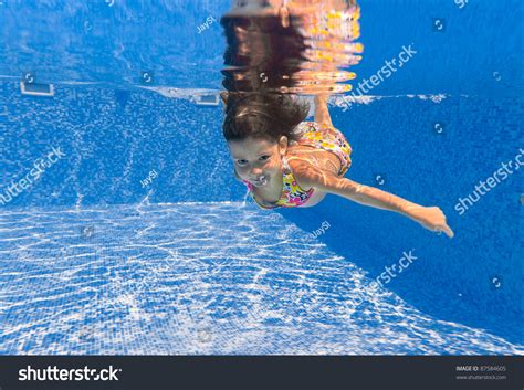 Smiling Happy Underwater Child In Swimming Pool Beautiful Girl Swim