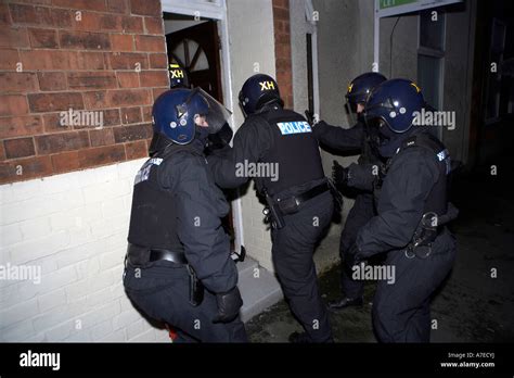 Police Enter A House After Breaking Down A Front Door During A Dawn