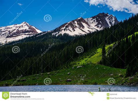 Colorado Spring Peaks Snow Tops Green Valley Pine Forest Stock Photo