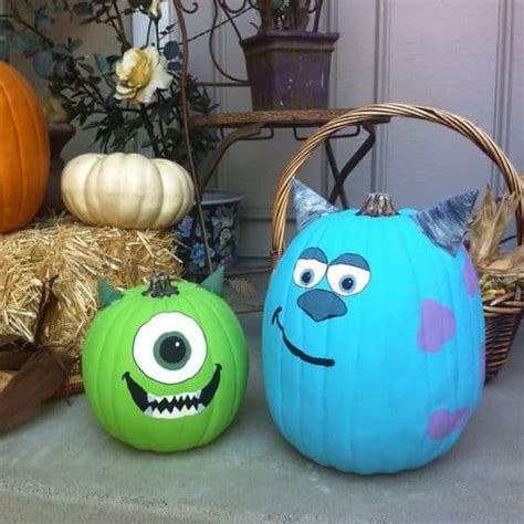 Two Pumpkins With Faces Painted On Them Sitting In Front Of A Basket