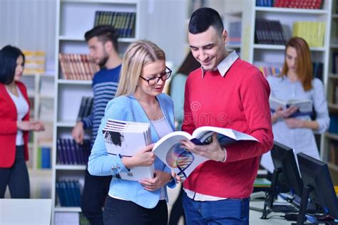 Two Young Students Working Together At The Library Stock Image Image