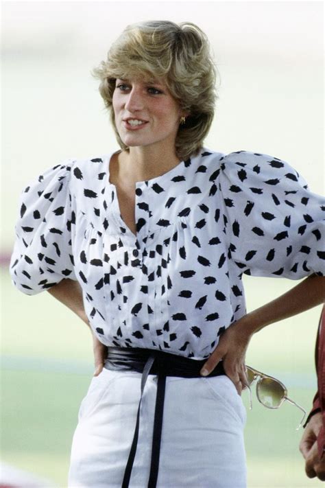 A Woman With Her Hands On Her Hips Wearing White And Black Polka Dot