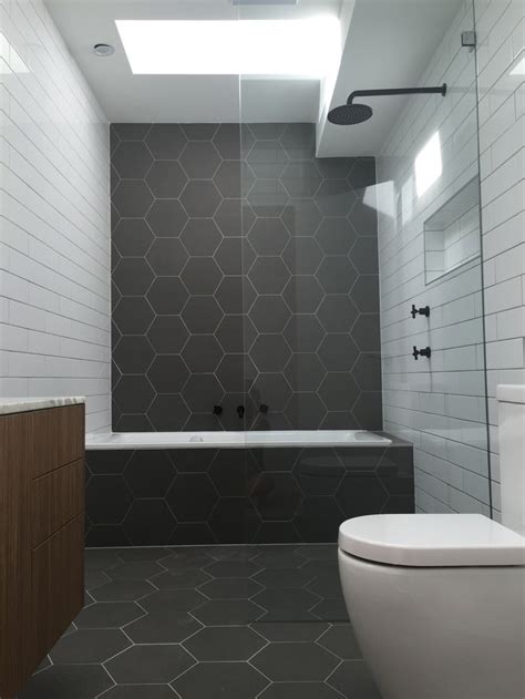 Gray hexagon bathroom tile is particularly intriguing variant for a bathroom as its color in conjunction with unique shape will help… Hexagonal tiles. Monochrome bathroom. Matt black fittings ...