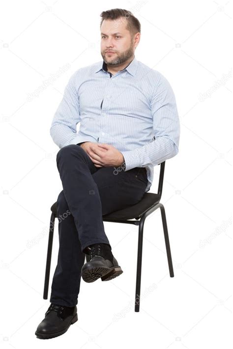 Man Sitting Cross Legged In Chair