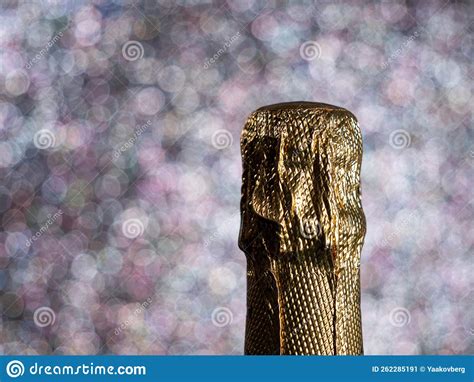 Bottle Of Champagne With Gold Glitter On A Shiny Background Stock