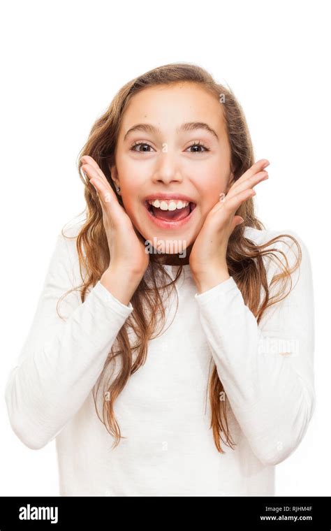 Smiling Young Girl Looking Happily Surprised With Hands On Her Chin Isolated On White Background