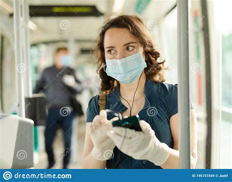 Female In Disposable Mask With Phone In Streetcar Stock Image Image