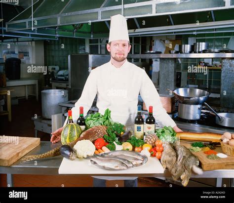 Professional Chef In Hotel Kitchen With Display Of Fresh Local Stock