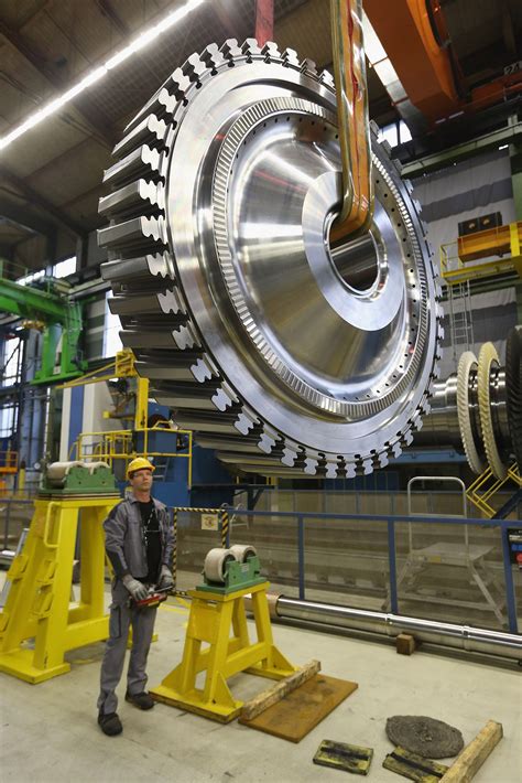 A Worker With A Disc For A Gas Turbine At The Siemens Gas Turbine Plant
