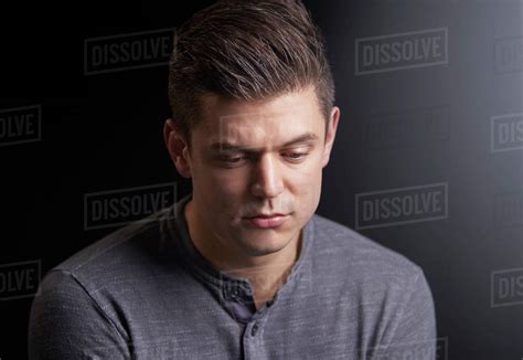 Portrait Of A Worried Young Man Looking Down Stock Photo Dissolve