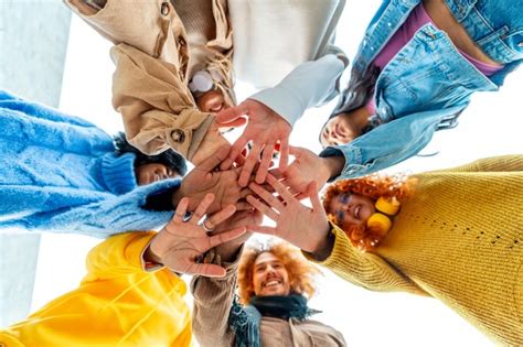 Premium Photo Group Of Diverse Young People Join Hands In Circle