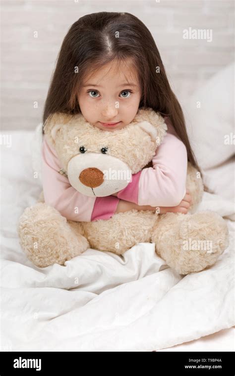 Adorable Little Child Girl Hugging Teddy Bear In Bed In Morning Stock