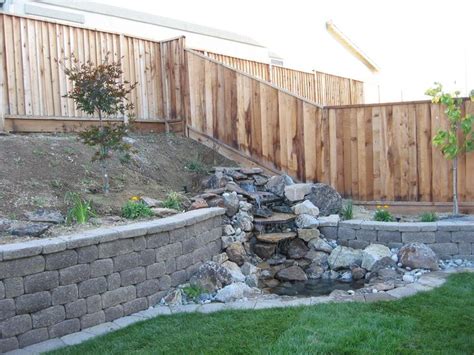 Water Feature Integrated Into Retaining Wall Though The Wall Should Be