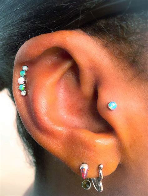 A Close Up Of A Person With Ear Piercings On Their Left And Right Ears