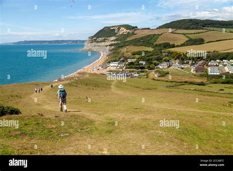 Walkers Heading Down To Eype Mouth Beach Along The South West Coast