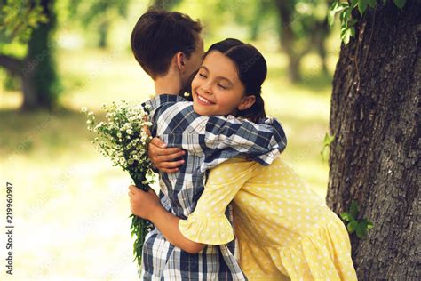 Sweet Little Girl Hugging Boy Happy Young Lady In Yellow Dress Smiling