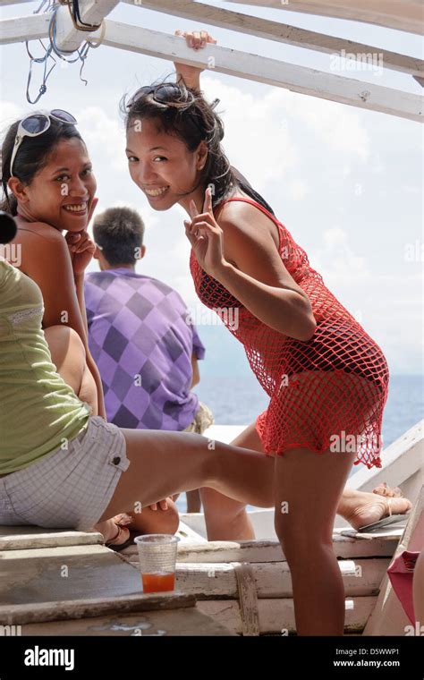 2 Cute Pretty Young Asian Women On A Boat 1 With Braces Smiling