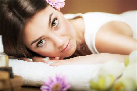 Massage Beautiful Woman At The Spa Gentle Look Flowers In Hair The Concept Of Health And