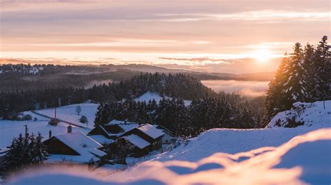 Download Wallpaper 2048x1152 Sunset Snow Houses Mountains Winter