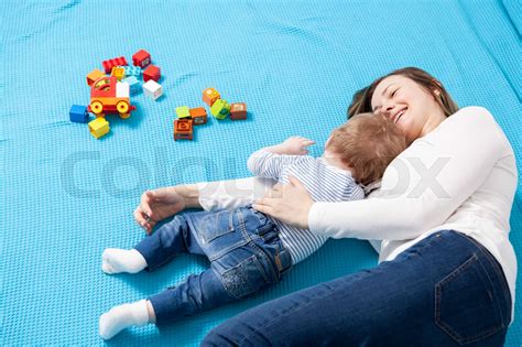 Mother And Son Laying Together On The Floor Stock Image Colourbox