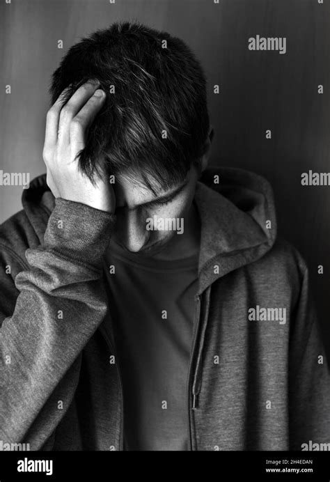 Black And White Photo Of Sad Young Man By The Wall Stock Photo Alamy