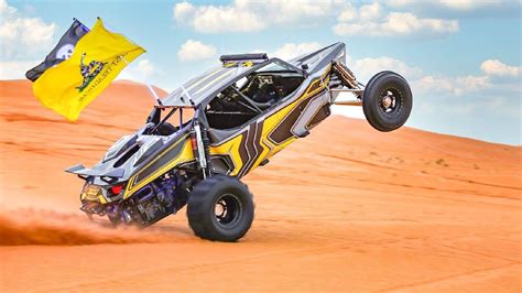 A Yellow And Black Buggy In The Sand With A Flag Flying From It S Side