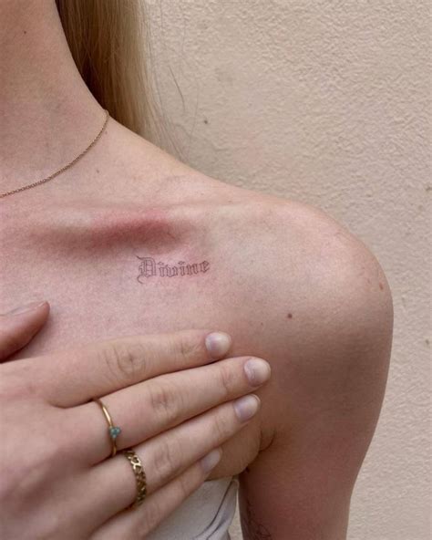 Divine Lettering Tattoo Located On The Collarbone