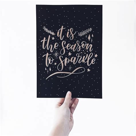 Someone Holding Up A Card That Says It Is The Season To Sparkle With