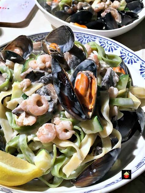 Divide pasta into portions and spoon sauce on top; Creamy Garlic Seafood Pasta, with a delicious creamy white ...