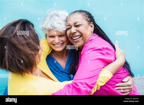 Happy Multiracial Senior Women Having Fun Hugging Each Other Outdoor Older Community Lifestyle