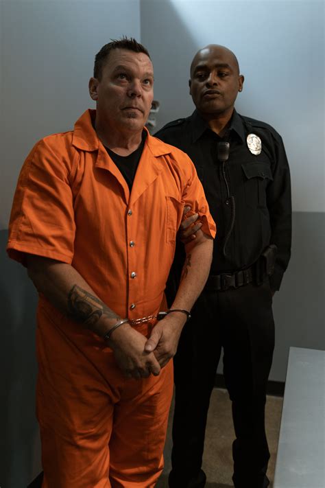 Man in Black Suit Jacket Standing Beside Man in Orange Jacket · Free
