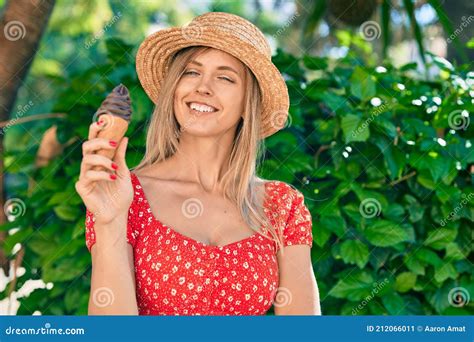 Young Blonde Tourist Woman Wearing Summer Style Eating Ice Cream At The