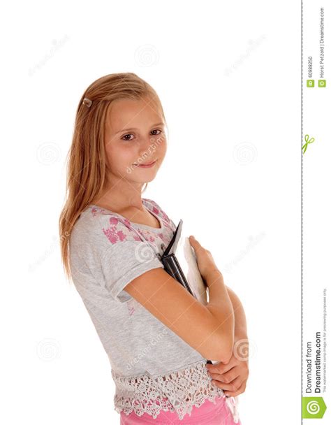 Schoolgirl Holding Her Books To Her Chest Stock Photo