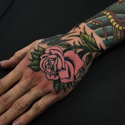 Traditional Pink Rose Tattoo Inked On The Left Hand And Wrist Pink
