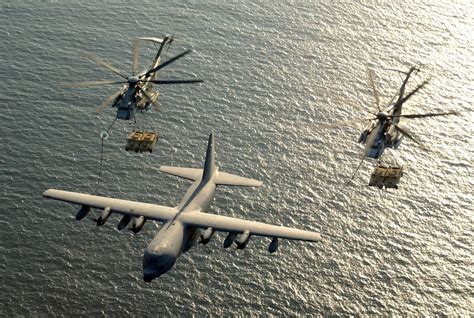 Two Marine Ch 53e Helicopters Each Carrying Two Humvees Undergo Aerial