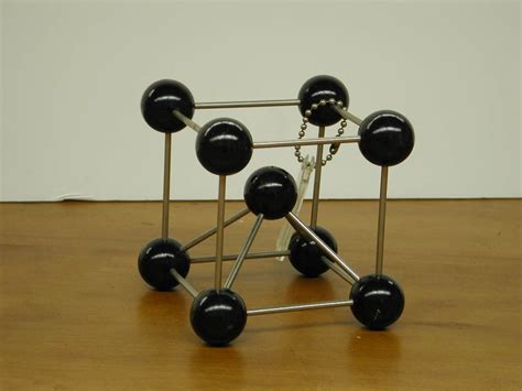 Calculate the dimensions of a cube that would contain one mole of na. bravaismodels