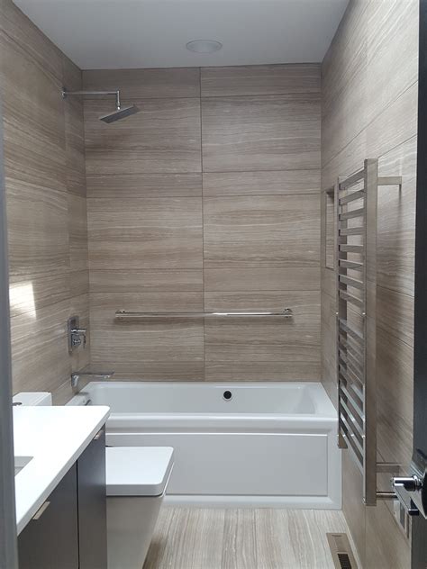 Learn more about what dimensions your dream shower may need here. Large striated tiles, heated towel bar, recessed shampoo ...